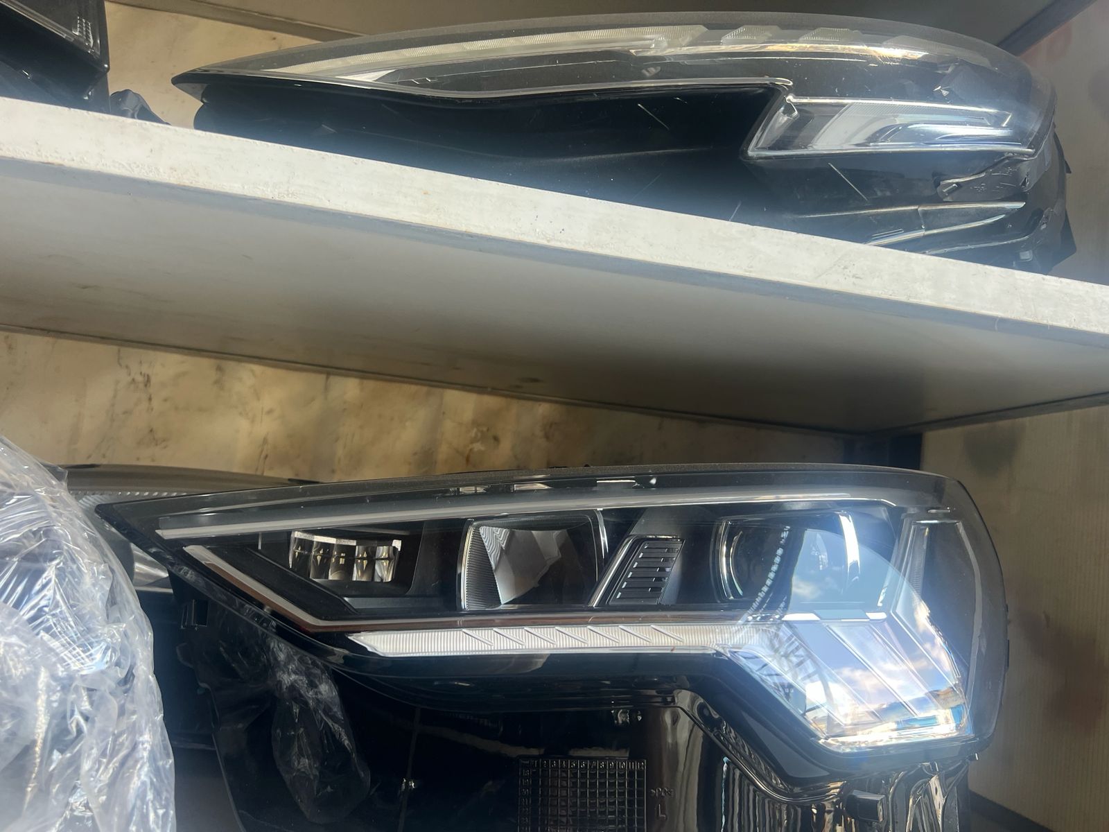 Audi LED headlights stored on warehouse shelving